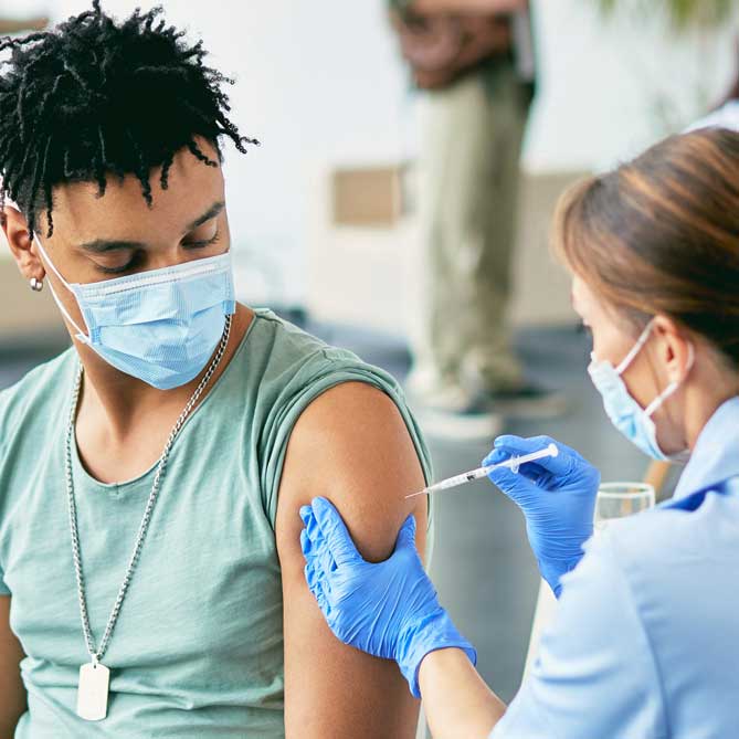 man receiving a vaccine at a health clinic
