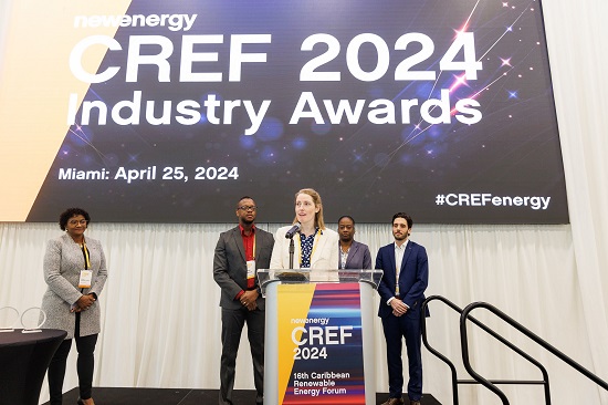 Christina Becker-Birck speaking at podium onstage at CREF conference with colleagues in the background