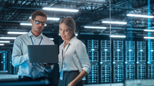 Female Chief Engineer Talks with Electronics Specialist, Explaining Things, While Works on Laptop Computer and Agrees with Her