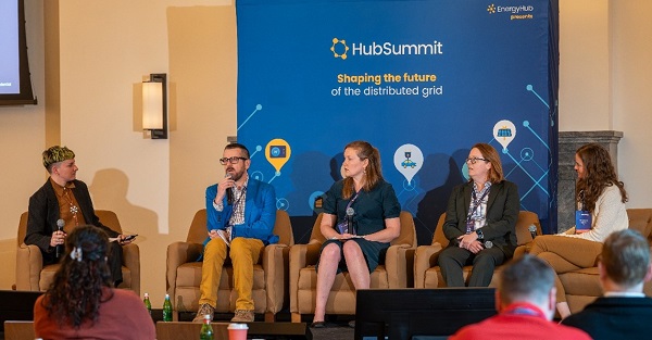 Panelists sitting on stage for presentation at HubSummit