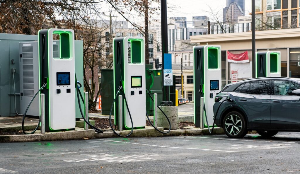 Electric car charging in a city parking lot
